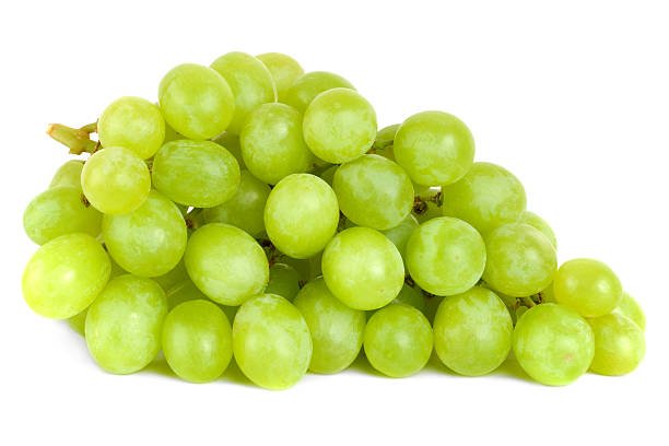 A shot of a bunch of green grapes, laying and isolated on white.