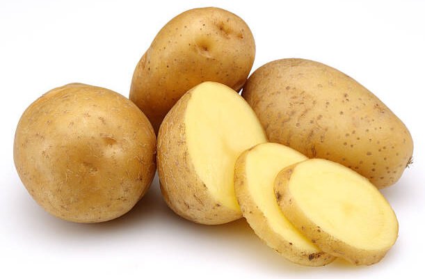 raw potatoes and slices isolated on white background